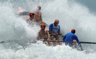 Swamped: The Red Rock-Corindi boat crew pounds through the waves before eventually being tipped into the huge seas smashing Woolgoolga Beach. Swamped: The Red Rock-Corindi boat crew pounds through the waves before eventually being tipped into the huge seas smashing Woolgoolga Beach.